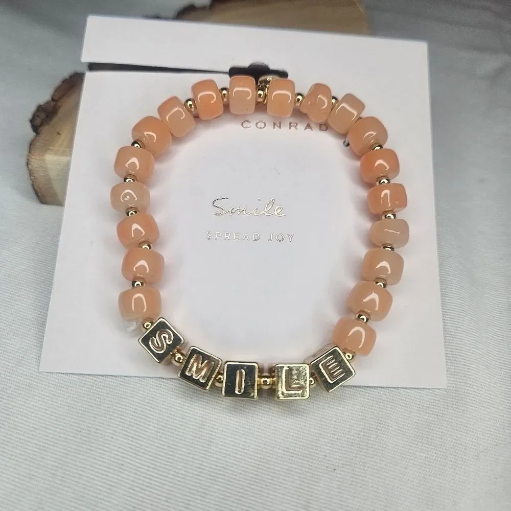 Lauren Conrad Gold Tone Metal And Peach Glass Bead Stretch Smile Bracelet